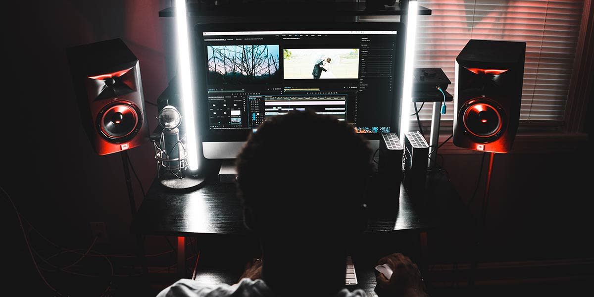 man-editing-video-in-the-dark-on-a-imac