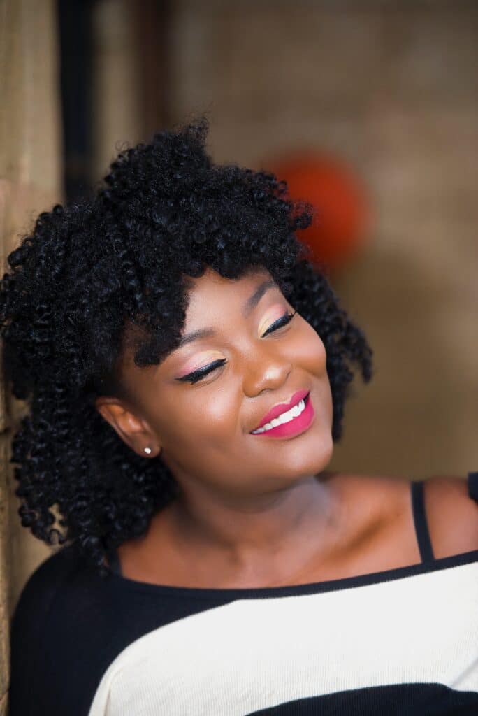 smiling black woman with magenta-red lipstick