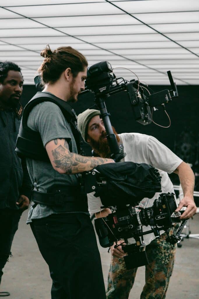 two men holding video cameras