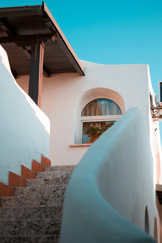 white painted building at top of curving stairs