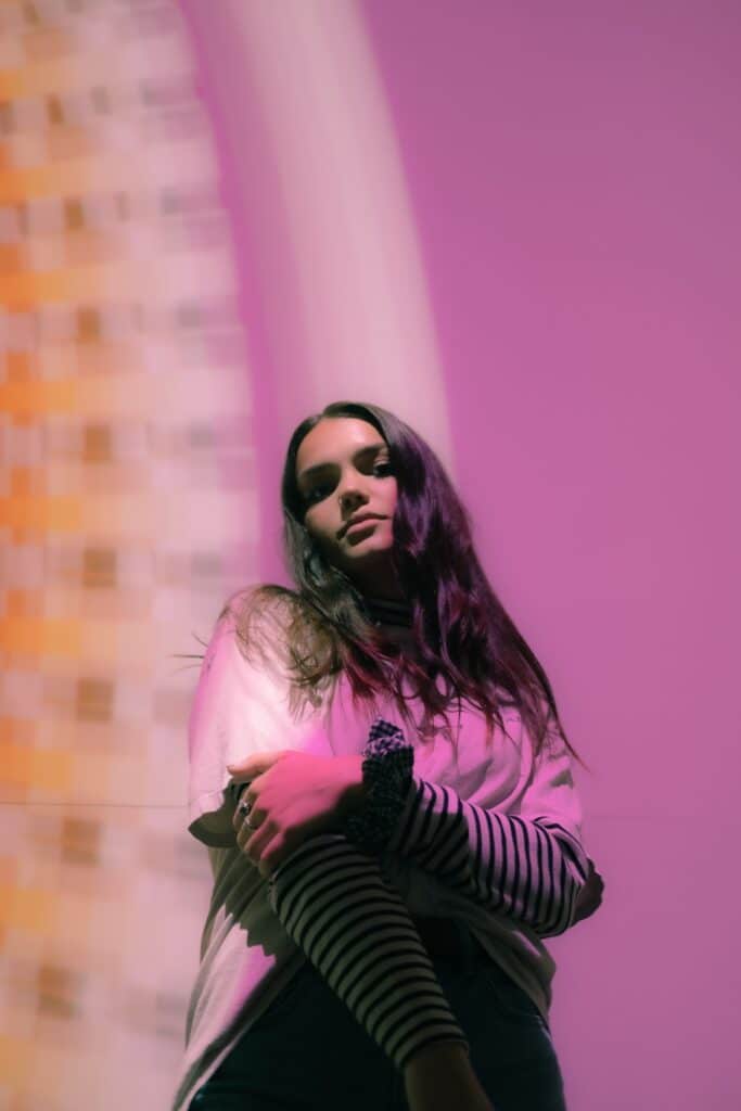 woman in yellow and magenta colored light