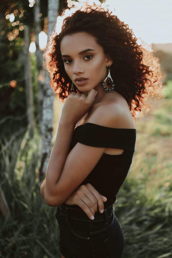 woman looking at camera and wearing off the shoulder top